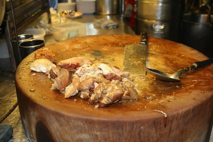 Stewed pork leg on a wooden chopping block